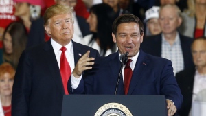 FILE- President Donald Trump stands behind gubernatorial candidate Ron DeSantis at a rally in Pensacola, Fla., Nov. 3, 2018. (Butch Dill / The Associated Press)
