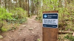Signs asking trail users to leash up their dogs and stay on designated paths have been vandalised multiple times, police say. (North Vancouver RCMP handout)