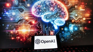 The OpenAI logo is seen displayed on a cellphone with an image on a computer monitor generated by ChatGPT's Dall-E text-to-image model, Dec. 8, 2023, in Boston. (AP Photo/Michael Dwyer, file)