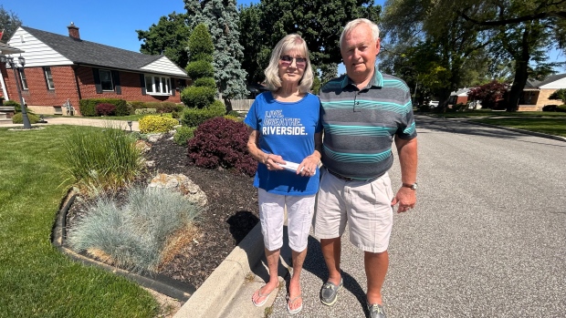Beverley and John Holmes out front of the Riverside home in Windsor, Ont., on May 23, 2024, where the landscaping on their front lawn is the subject of a non-right-of-way encroachment complaint. (Rich Garton/CTV News Windsor)