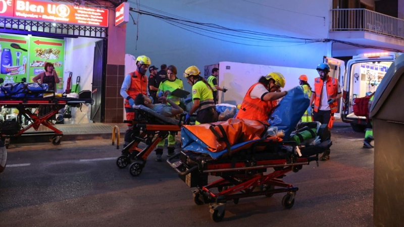Medics take injured people away from a building that collapsed in Palma de Mallorca, Spain, Thursday May 23, 2024. (Isaac Buj / Europa Press via AP)