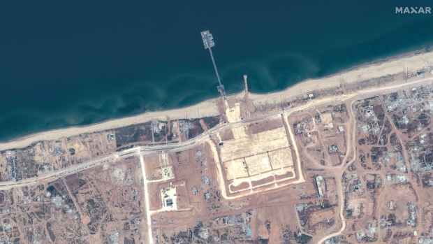 This image released by Maxar Technologies shows the overview of the new pier off Gaza and aid trucks on Saturday, May 18, 2024. (Satellite image ©2024 Maxar Technologies via AP)