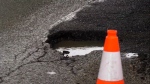 A large pothole on 16 Avenue N.W. under the Sarcee Trail overpass caused significant damage to at least six vehicles on Thursday evening.