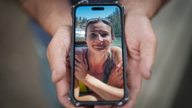 Jason Gaudreault, whose partner Tatjana Stefanski was found dead on April 14 after disappearing a day earlier, shows a photograph of her on his phone, in Lumby, B.C., on Monday, May 13, 2024. THE CANADIAN PRESS/Darryl Dyck
