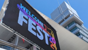 A brightly coloured sign in downtown Kitchener announces the arrival of WelcomeFest on May 24, 2024. (Dan Lauckner/CTV News)