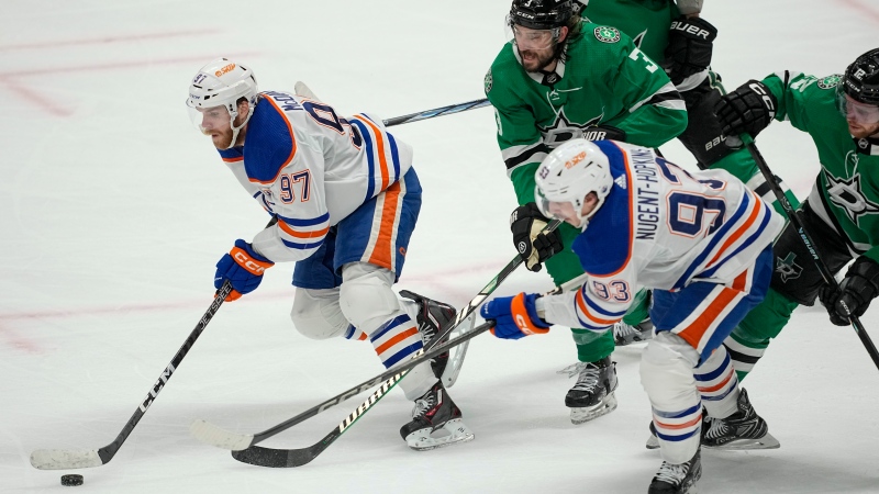 Edmonton Oilers centre Connor McDavid (97) skates with the puck as teammate Ryan Nugent-Hopkins (93) and Dallas Stars defenceman Chris Tanev (3) chase after him during Game 1 of the NHL Western Conference Final on May 23, 2024, in Dallas. (Tony Gutierrez/Associated Press)