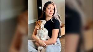 Kristie Pereira and her dog Beau pose for a photo in Laurel, Md., in January 2023. Pereira is seeking answers after the sick dog she took to a shelter to have euthanized turned up more than a year later on a rescue adoption site. (Kristie Pereira via AP)