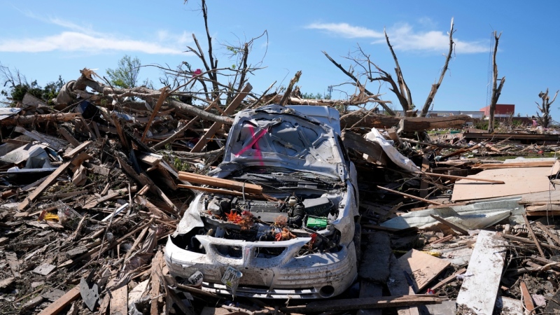 A tornado damaged car sits in a pile of debris, Thursday, May 23, 2024, in Greenfield, Iowa. (AP Photo/Charlie Neibergall, File)