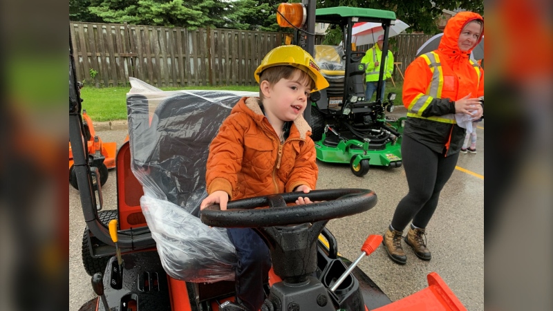 Three-year-old Luca Laureano rides a tractor at the 'Touch A Truck' event at Earl Nichols Recreation Centre in London, Ont. on May 25, 2024. (Bryan Bicknell/CTV News London)
