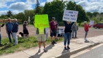 Around 30 people gathered at the corner of Mill Road and Toombs Street to voice their concerns over the AIM Recycling operation in Moncton, N.B., on May 25, 2024. (Derek Haggett/CTV Atlantic)