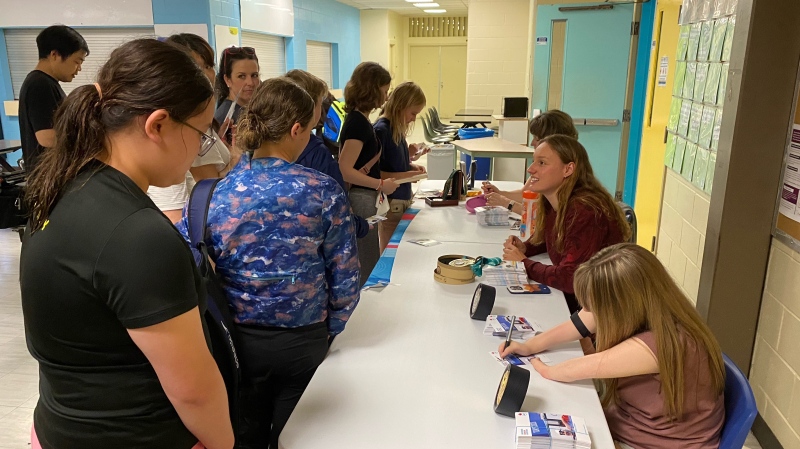 Hundreds of young swimmers in Moncton waited in line Saturday to meet Olympians Marianne Limpert, Danielle Dorris and Brooklyn Douthwright. (Derek Haggett/CTV News)