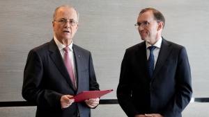 Prime Minister of the Palestinian Authority Mohammed Mustafa, left, speaks after receiving a document handed over by Norway's Foreign Minister Espen Barth Eide, right, prior to a meeting for talks on the Middle East in Brussels, Sunday, May 26, 2024.  (AP Photo/Virginia Mayo)