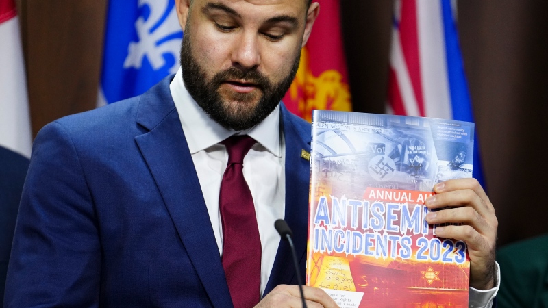 Richard Robertson, B'nai Brith Canada Director of Research and Advocacy, holds up an Annual Audit of Antisemitic Incidents in Canada during a press conference in Ottawa on Monday, May 6, 2024. THE CANADIAN PRESS/Sean Kilpatrick