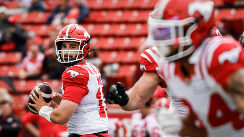Calgary Stampeders quarterback Jake Maier (12) looks for a receiver during first half CFL preseason football action against the B.C. Lions in Calgary, Saturday, May 25, 2024. (THE CANADIAN PRESS/Jeff McIntosh)
