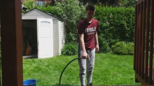 Kye Philips, a Grade 8 student at Loyola High School, helps with springtime cleaning for seniors in Montreal West on Saturday, May 25, 2024. (CTV News)
