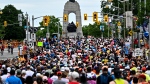 Runners make their way towards the National War Memorial at the start of the marathon of the Ottawa Race Weekend in Ottawa, on Sunday, May 26, 2024. THE CANADIAN PRESS/Justin Tang