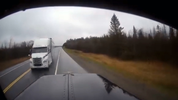 Ontario Provincial Police released a video on social media on May 25, 2024 showing a commercial motor vehicle driver nearly colliding with another tractor-trailer on Highway 17 near Thessalon, Ont. (Supplied/Ontario Provincial Police)