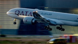 A Qatar airways plane lands at the airport in Frankfurt, Germany, as the sun rises on Sept. 25, 2023. (AP Photo/Michael Probst, File)