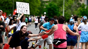 Members of a run club cheer on runners as they enter the final stretch of the marathon and half marathon of the Ottawa Race Weekend in Ottawa, on Sunday, May 26, 2024. THE CANADIAN PRESS/Justin Tang