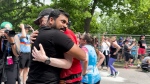 Ottawa Mayor Mark Sutcliffe and Dhanushka Wickramasinghe hug after Sutcliffe completed the Ottawa marathon. Wickramasinghe is the sole survivor of a mass homicide in March in which his wife, four children and a family friend were killed. (Jackie Perez/CTV News Ottawa)