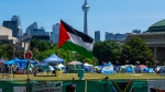 A Palestinian flag flies over the pro-Palestinian encampment set up at the University of Toronto campus in Toronto on Sunday, May 26, 2024. Pro-Palestinian protesters who have been camped out at the University of Toronto for weeks say they have no plans to honour the terms of a trespass notice issued by the school and clear the demonstration site by 8 a.m. THE CANADIAN PRESS/Frank Gunn
