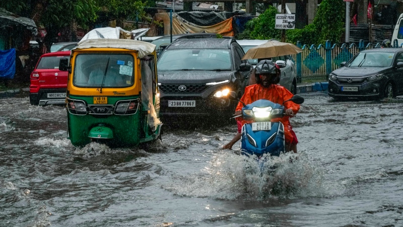 Vehicles move through a waterlogged street in Kolkata, India, on Monday, May 27, 2024. (AP Photo/Bikas Das)