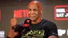 Mike Tyson gestures to the crowd during a news conference promoting his upcoming boxing bout against Jake Paul, Thursday, May 16, 2024, in Arlington, Texas. The fight is scheduled for July 20. (AP Photo/Sam Hodde)