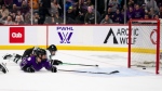 Minnesota forward Grace Zumwinkle (13) slides the puck into the empty Boston net as Boston's Megan Keller defends during the third period of Game 3 of the PWHL hockey championship series, Friday, May 24, 2024, in St. Paul, Minn. (Angelina Katsanis / Star Tribune via AP)