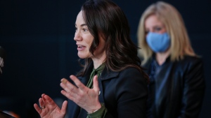 Shannon Phillips, speaks as Alberta NDP Leader Rachel Notley looks on at an announcement in Calgary, Alta., Monday, March 15, 2021. (THE CANADIAN PRESS/Jeff McIntosh)
