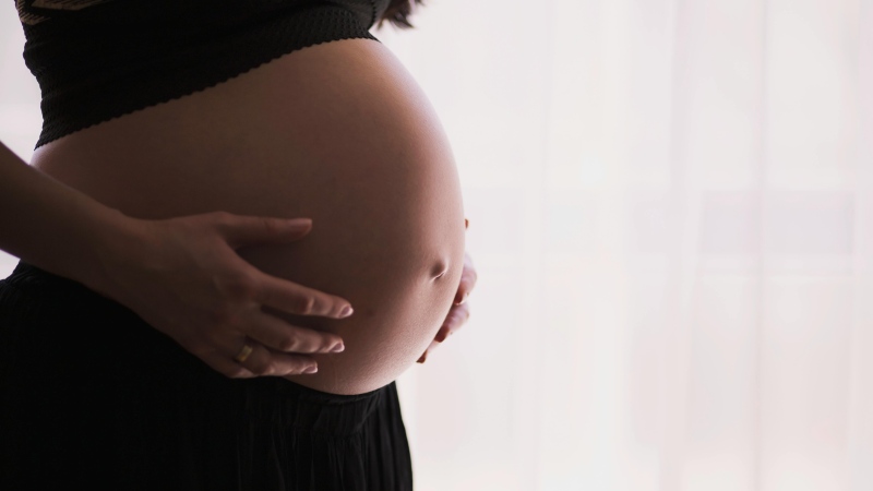 A pregnant person is shown in this stock photo. (Pexels)