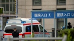 FILE - An ambulance drives through an entrance of a hospital in China on Thursday, April 20, 2023.  (AP Photo/Mark Schiefelbein)
