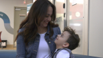 Andrea Fernandez (left) and her son, Jakob Gusiak (right), share a smile as they thank donors at the Canadian Blood Services location in Edmonton for their contributions on May 27, 2024. (Miriam Valdes-Carletti/CTV News Edmonton)