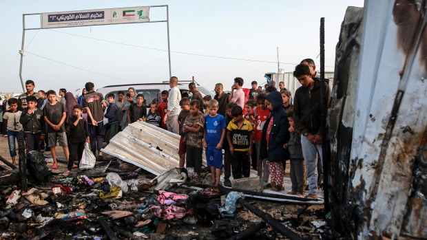 Palestinians look at the destruction after an Israeli strike where displaced people were staying in Rafah, Gaza Strip, Monday, May 27, 2024.  (AP Photo/Jehad Alshrafi)