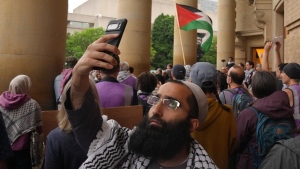 People attend a rally outside Convocation Hall on the University of Toronto campus on Monday, May 27, 2024. The U of T says it's taking legal action in an effort to clear an encampment of pro-Palestinian protesters from its downtown campus. THE CANADIAN PRESS/Chris Young
Chris Young