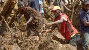 In this photo released by UNDP Papua New Guinea, villagers search through a landslide in Yambali village, in the Highlands of Papua New Guinea, Monday, May 27, 2024. (Juho Valta/UNDP Papua New Guinea via AP)