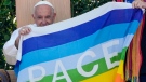 Pope Francis holds a peace flag during the 'Arena of Peace - Justice and Peace Will Embrace' meeting at Verona's ancient Roman arena, part of his one-day pastoral visit to the northern Italian town of Verona, Saturday, May 18, 2024. (Gregorio Borgia / AP Photo)