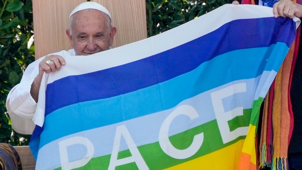 Pope Francis holds a peace flag during the 'Arena of Peace - Justice and Peace Will Embrace' meeting at Verona's ancient Roman arena, part of his one-day pastoral visit to the northern Italian town of Verona, Saturday, May 18, 2024. (Gregorio Borgia / AP Photo)