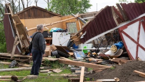 A man looks at the damage in Très-Saint-Rédempteur, Que., on Tuesday, May 28, 2024 after a tornado went through the prior evening. (Ryan Remiorz, The Canadian Press)