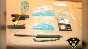 A search of a vehicle following a traffic stop on Highway 69 in Carling Township, Ont., on May 27, 2024, located a firearm, a high-capacity magazine, more than $1,300 in cash and an estimated $100,000 of suspected cocaine and fentanyl. (Supplied/Ontario Provincial Police)