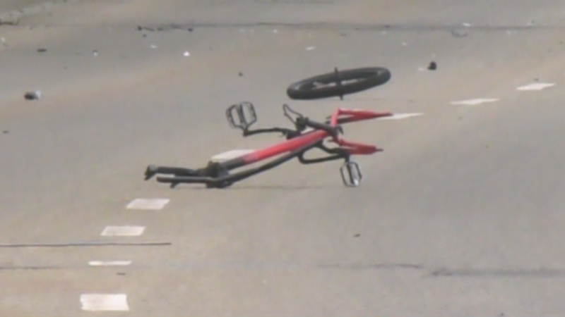 A broken bicycle laid on 34 Avenue in south Edmonton where a minor was killed in an apparent hit-and-run on May 29, 2024. (Matt Marshall / CTV News Edmonton) 