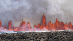A volcano spews lava in Grindavik, Iceland, Wednesday, May 29, 2024. (AP Photo/Marco di Marco)
