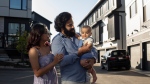Zeel Shah and her family pose in front of their home after moving from Toronto to Edmonton on Oct. 7, 2022. (Amber Bracken / The Canadian Press) 