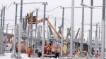 Hydro Quebec employees work on the construction site of a new substation in Montreal, Tuesday, Dec. 12, 2023. (Christinne Muschi/The Canadian Press)