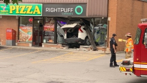 Emergency crews are seen at Right Puff Cannabis in London, Ont. after a vehicle plowed through the front of the shop on May 29, 2024. (Marek Sutherland/CTV News London) 