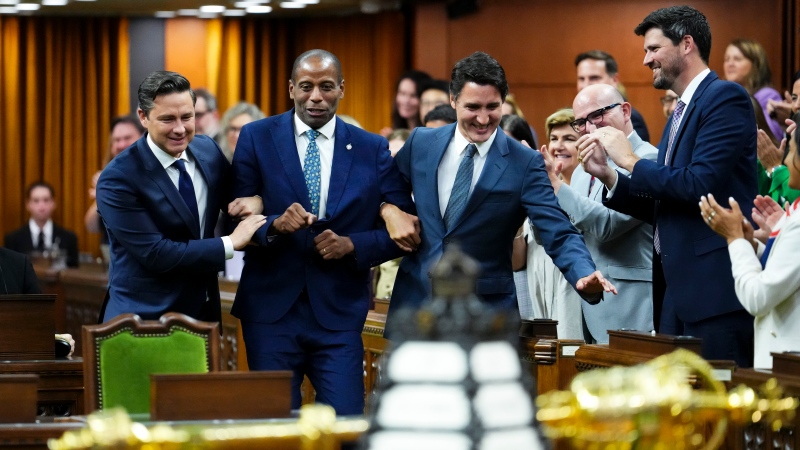 Newly elected Speaker of the House of Commons Greg Fergus is escorted into the House of Commons by Prime Minister Justin Trudeau and Conservative Leader Pierre Poilievre on Parliament Hill in Ottawa on Tuesday, Oct. 3, 2023. THE CANADIAN PRESS/Sean Kilpatrick