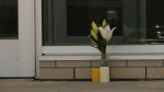 A vase with flowers sits in front of Bowness High School on May 29, 2024. (CTV News) 