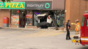Emergency crews were seen at Right Puff Cannabis in London, Ont. after a vehicle plowed through the front of the shop on May 29, 2024. (Marek Sutherland/CTV News London)