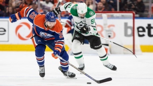 Edmonton Oilers forward Connor Brown carries the puck up ice as Dallas Stars forward Tyler Seguin gives chase  during Game 4 of the NHL Western Conference Final on May 29, 2024, ikn Edmonton. (Jason Franson/The Canadian Press)