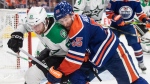 Dallas Stars defenceman Thomas Harley, left, and Edmonton Oilers forward Dylan Holloway battle for the puck during Game 4 of the NHL Western Conference Final on May 29, 2024, in Edmonton. (Jason Franson/The Canadian Press)