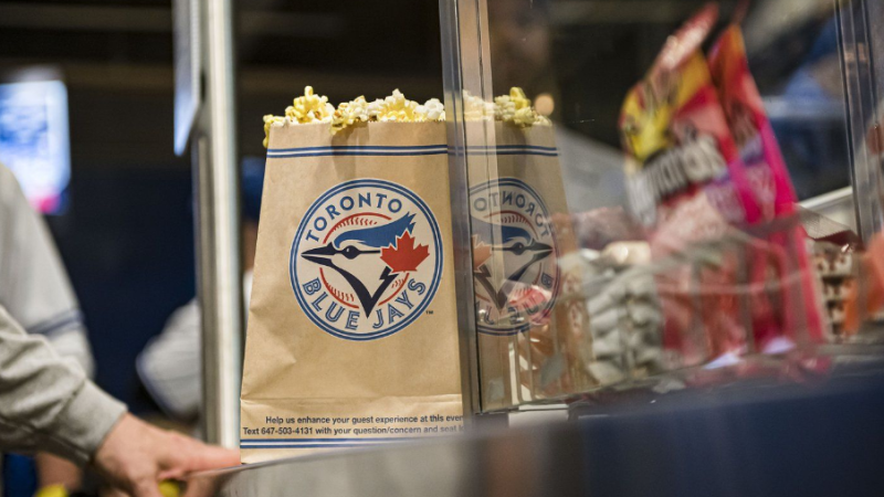 Fans line up for food during the Toronto Blue Jays home opener on Friday, April 8, 2022. THE CANADIAN PRESS/Christopher Katsarov